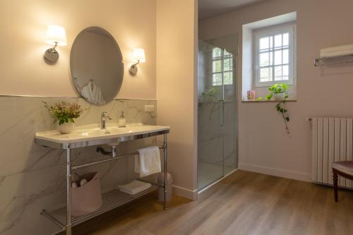 a bathroom with a sink and a mirror and a shower at La Reverdie in Cahuzac-sur-Vère