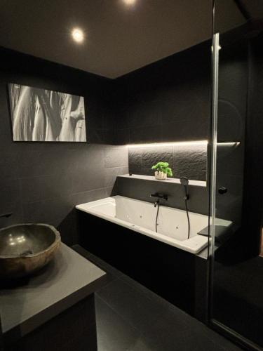 a bathroom with a sink and a bath tub at Luxury Summit Penthouse - Soldeu - By Ski Chalet Andorra in Soldeu