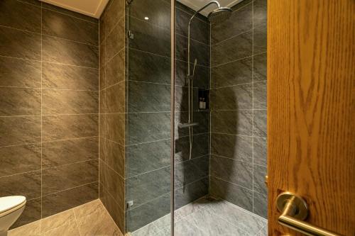 a bathroom with a shower with a toilet at Nam Dat Hotel by D'Lecia Ha Long in Ha Long