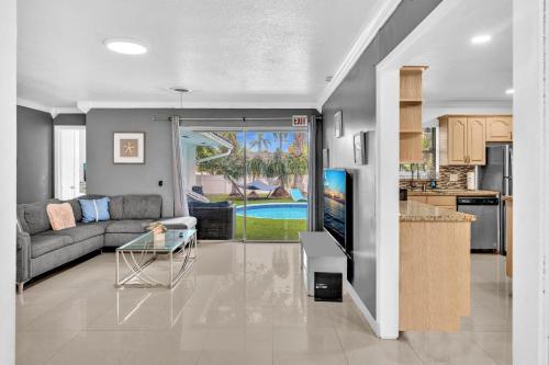 a living room with a couch and a table at Luxury Heated Pool Villa Hollywood Beach & Casino in Hollywood