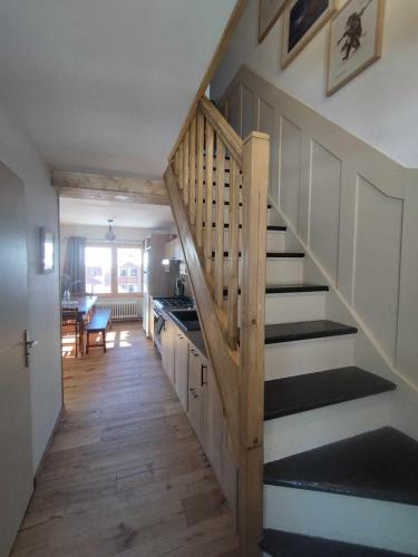 a hallway with a staircase in a house at Appartement skis aux pieds, à Peisey Vallandry in Landry