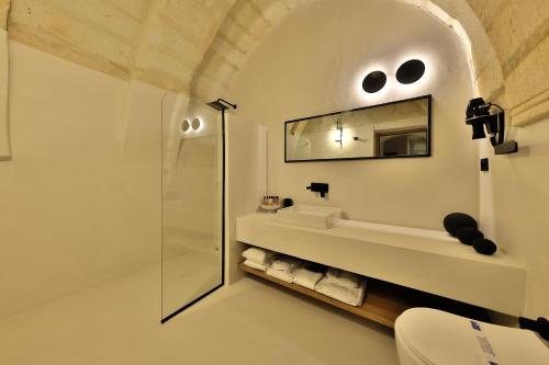 a bathroom with a shower and a mirror at Simurg Cave House in Urgup