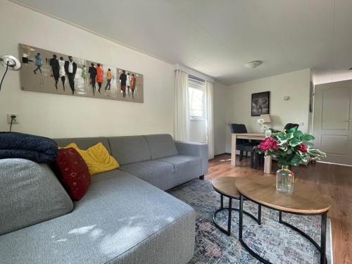 a living room with a couch and a table at Veluwe Vibes in Epe