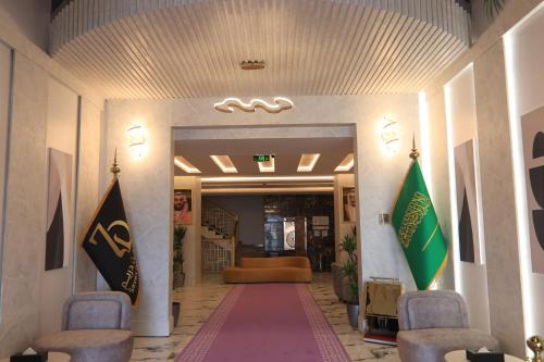 a hallway with two flags in a building at فندق سفن دريم in Al Kharj