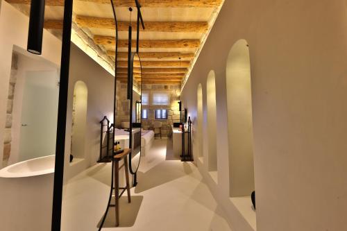 a long hallway with white walls and a wooden ceiling at Simurg Cave House in Urgup