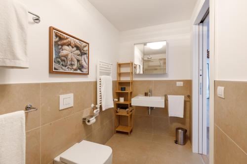 a bathroom with a sink and a toilet at Portopiccolo Apartments - Telgatino nel Golfo in Sistiana