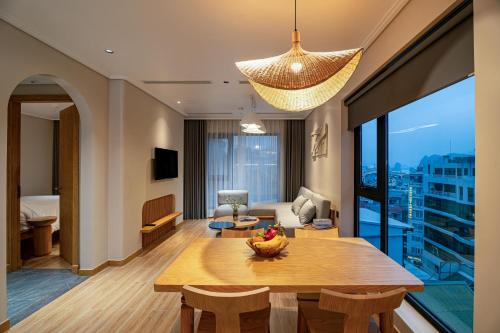 a living room with a dining table and a living room at Nam Dat Hotel by D'Lecia Ha Long in Ha Long