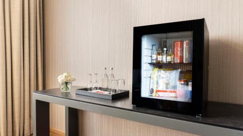 a shelf with a refrigerator on a wall at NH Collection Mexico City Airport T2 in Mexico City
