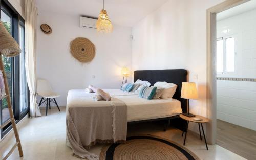 a bedroom with a bed in a white room at Bed & Breakfast La Vida en Rosa in Marbella