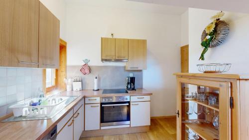 a kitchen with a sink and a stove at Familie Sponring - Maxnhagerhof in Weerberg