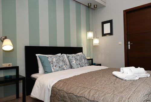 a bedroom with a bed with two towels on it at Grimani Pension in Nafplio