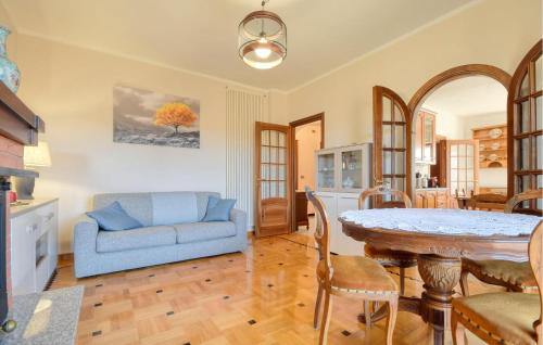 a living room with a blue couch and a table at Casa Lilly in Varese Ligure