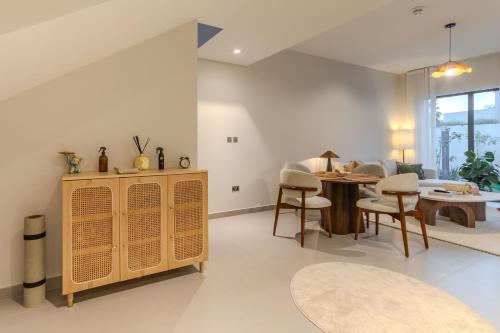 a living room with a table and chairs at Your Cozy Yas Island Escape in Abu Dhabi