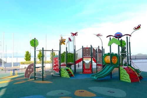 a childrens playground with a slide and a play structure at Amber Cove Melaka in Melaka