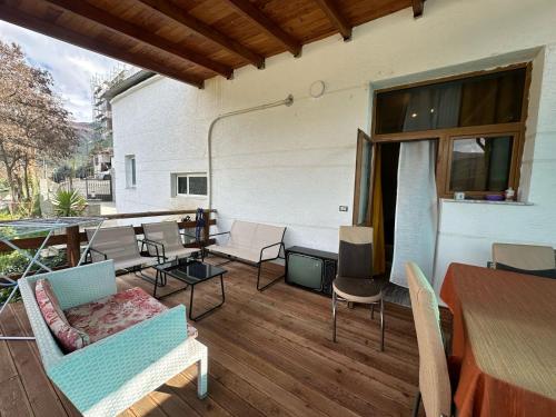 a patio with chairs and a table and a tableablish at Vladi's Home in Çorovodë