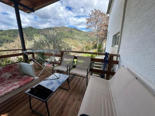 a porch with a couch and chairs on a balcony at Vladi's Home in Çorovodë