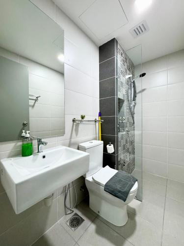 a bathroom with a sink and a toilet and a shower at Alinea Suites by Moka in Shah Alam