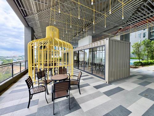 a room with a table and chairs and a chandelier at Alinea Suites by Moka in Shah Alam