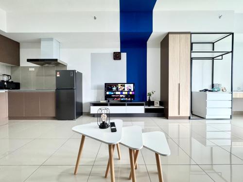 a kitchen with a white table and two white chairs at Alinea Suites by Moka in Shah Alam