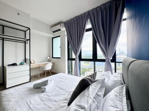 a bedroom with a bed with a large window at Alinea Suites by Moka in Shah Alam