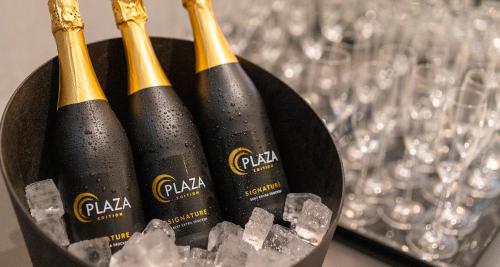 three bottles of champagne in a bucket of ice at PLAZA Premium München in Munich