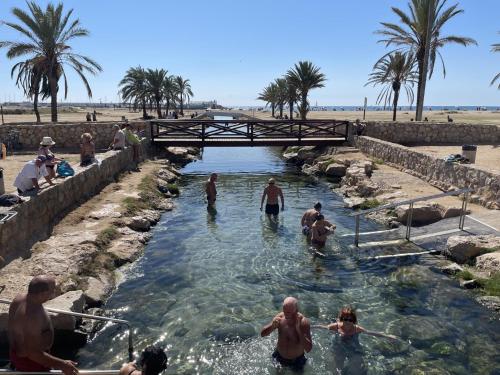 a group of people swimming in a river at Apartament inclusiu Coma-ruga in Comarruga