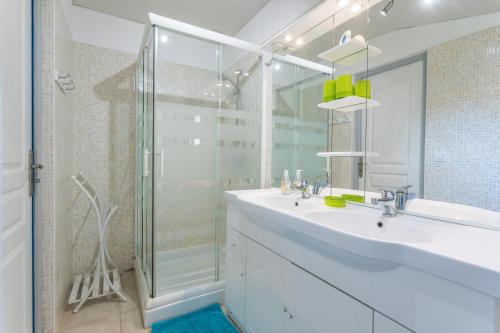 a white bathroom with a sink and a shower at Villa les Mimosas in Bormes-les-Mimosas