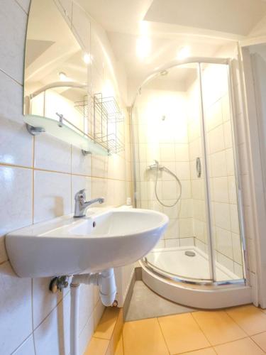 a bathroom with a sink and a shower at Pod Jesionem in Lubin