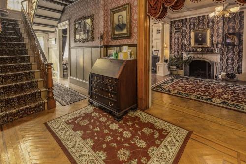 a living room with a dresser and a fireplace at The Emig Mansion in York