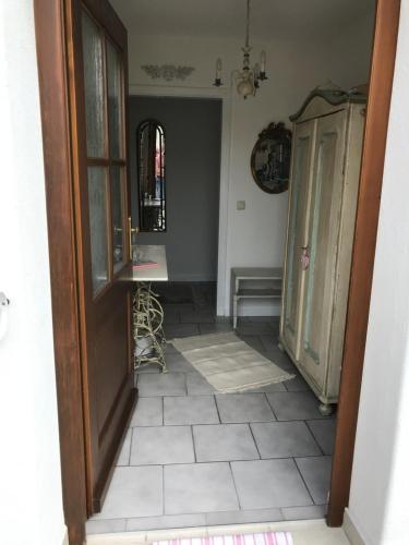 a hallway with a door and a tiled floor at Ferienwohnung Lau in Steingaden