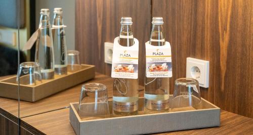 a couple of bottles and glasses on a counter at PLAZA Premium München in Munich