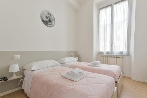 Un pat sau paturi într-o cameră la Le Case sul Parco 2