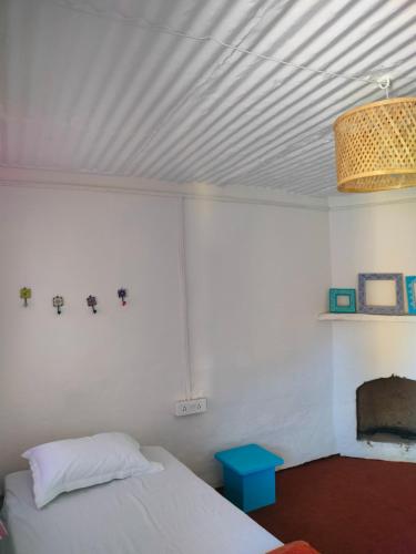 a bedroom with a bed and a chandelier at The Alpine Vista in Almora
