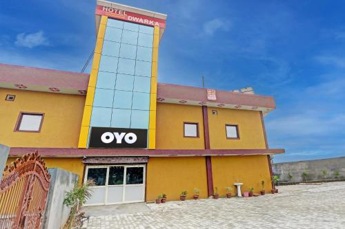 a yellow building with a wvu sign on it at Hotel O Dwarka in Alīgarh