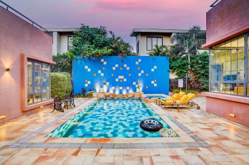 a swimming pool in the middle of a house at ELIVAAS Villa 39 - Serene 6 BHK Retreat with Pvt Pool, Gaming Zone & Balcony in Lonavala