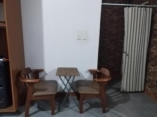 a room with two chairs and a table and a heater at R & J Homestay in Naga Cebu in Tina-an