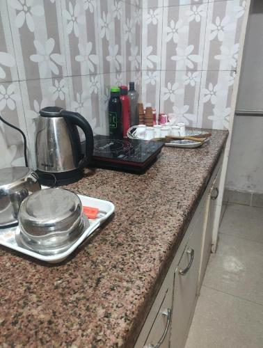 a kitchen counter with a tea kettle on it at Anjani Home - 3Bhk Homely & GroundFloor Appartment for Families in Varanasi