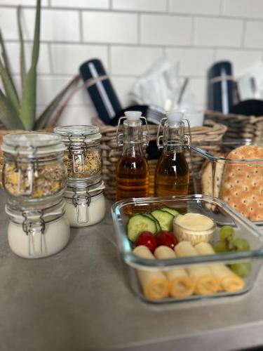 a counter with jars of food and a tray of vegetables at Spirit Gästis in Ekeby