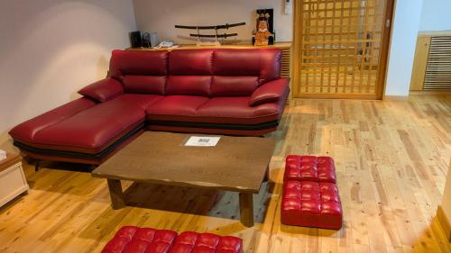a living room with a red couch and a coffee table at condominium SAKURA B5 in Hakone