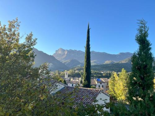 a view of a city with mountains in the background at Le Cocon des Trois Marmottes in Saillans