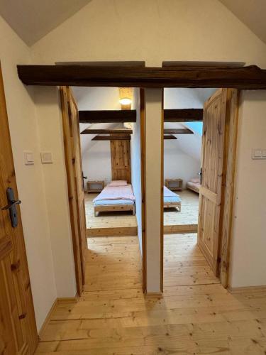a hallway with two bunk beds in a room at Apartmán Maštal in Osek