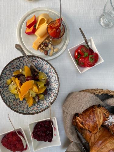 a table topped with plates of food and fruits at Huis Dujardin Bed&Breakfast in Antwerp