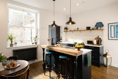 a kitchen with a large island with a counter top at The Residence, Luxury City Stay in York