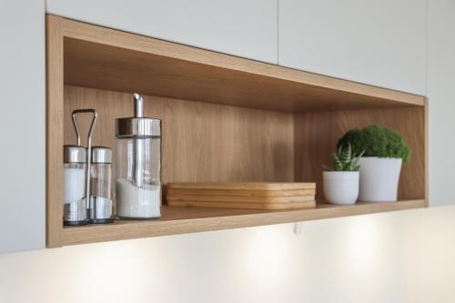 a wooden shelf with bottles and potted plants on it at Säntisblick Apartment in Schwarzach