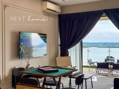 a dining room with a table and a view of the water at Country Garden Seaview Suite by Nest Home at Danga Bay in Johor Bahru