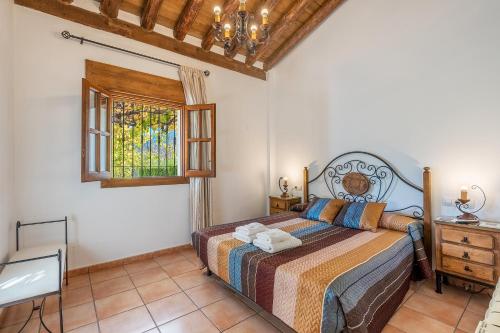 a bedroom with a bed and a window at Casa Rocío Castril in Castril