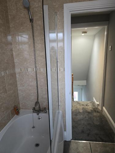 a bathroom with a bath tub and a shower at Aldam House in Darlington