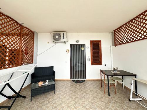a living room with a table and a chair at B&B Verzavò in Cetraro