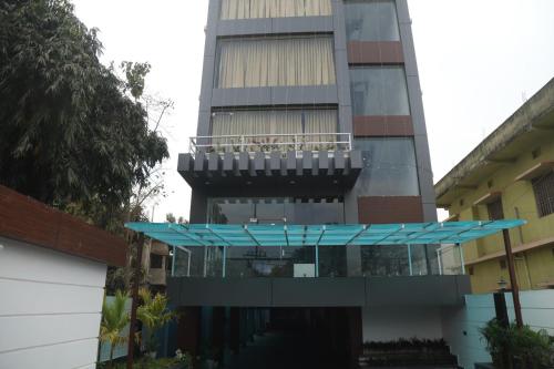 a building with a balcony in front of it at Geetanjali International Annex a unit of Geetanjali International in Deoghar