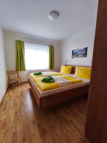 a bedroom with a large bed with yellow sheets at Ferienhaus Marianne in Zinnowitz